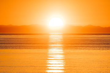 Orange sunset over the Olympic Mountains and the Salish Sea - Powered by Adobe