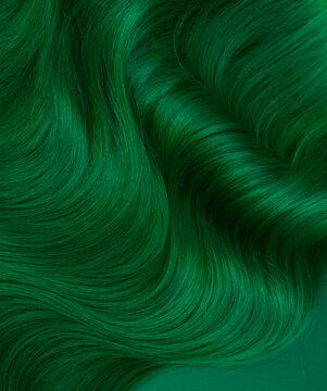 Unusual bright green natural hair colored with pigments. Beauty salon background for stories.