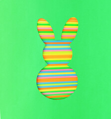 Creative colorful Easter bunny or rabbit shape on green background. Spring Easter holiday minimal concept. Flat lay, top view.