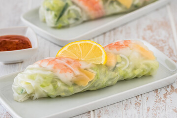 Summer roll with salad and prawns on a white wooden background, japanese, vietnamese, asian food