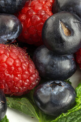 Assortment of red fruits, strawberries, blueberries and raspberries, close up