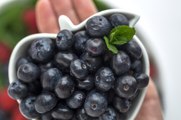 Assortment of red fruits, strawberries, blueberries and raspberries, close up