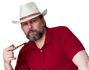 Bearded middle aged man in white sombrero and smoking pipe in hand isolated on white. A man in a cowboy hat. A middle-aged man with a gray beard is looking at us.