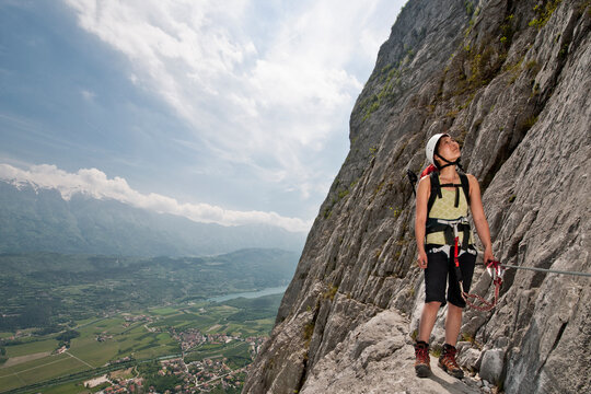Woman climbing up the Che Guevara Via Ferrata in Italy