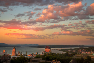 Fototapeta na wymiar Sunset on Old Quebec city with St-Lawrence river and Orlean's island as background.
