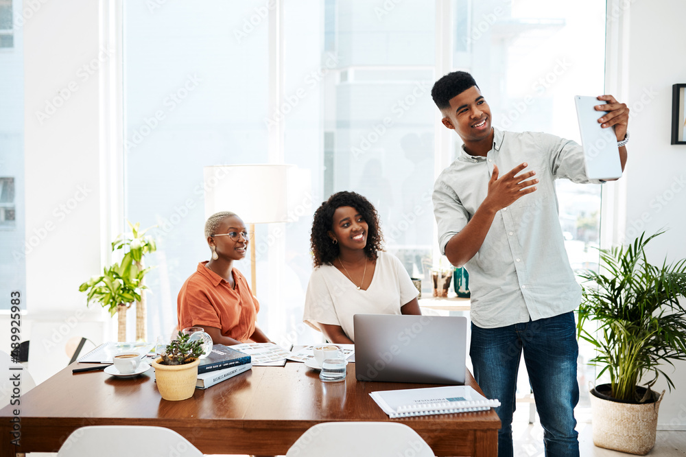 Poster technology broadens what they are able to do. shot of a group of businesspeople using a digital tabl