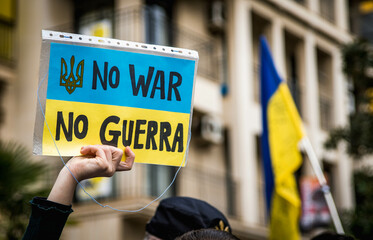 
No War Poster with the Ukrainian Flag in the Middle of a Demonstration for Peace with People and...