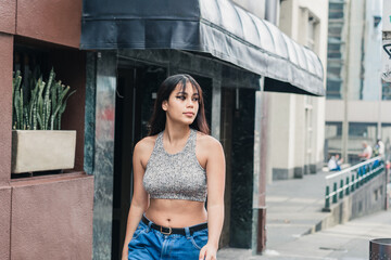 beautiful brunette, latina woman walking the streets in the city of Pereira-Colombia. girl shopping...