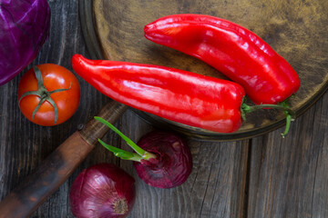 Organic, vegetarian fresh vegetables, red tomato, pepper, cabbage, onion, on wooden background. Food concept. Vintage still life with old cooper