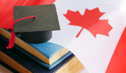 Graduation cap on stack of books. Canada education concept. Class of 