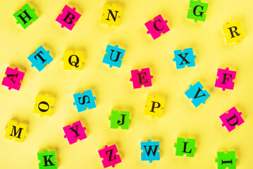 Top view of english alphabet from multi-colored puzzles Simulator for learning English. Educational process. School, lessons, pedagogy. The concept of thinking development, grammar.