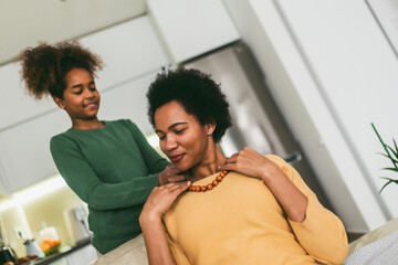 Woman and girl at home celebrating mother's day.