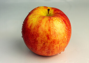 Red apple close-up on a light background.