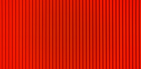 Texture of a red corrugated sheet metal facade. Close up of an exterior wall of a warehouse in the industrial area.