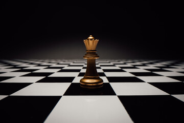 Chess piece queen on a chessboard against neutral background. Chess as a symbol of strategy, intelligence, power and business. Dark mood.