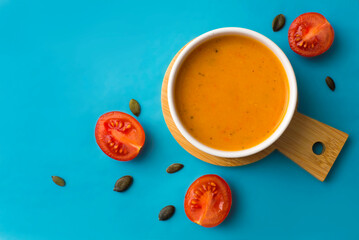 vegetarian pumpkin soup, on a blue background, top view