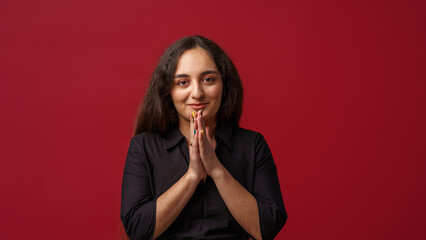 Portrait of a happy girl with dark long hair, smiling. A young woman, emotionally excited, looks...