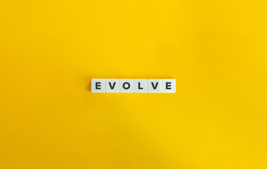 Evolve Word on Letter Tiles on Yellow Background. Minimal Aesthetics.