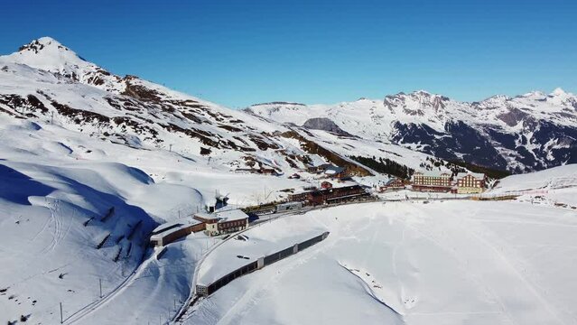 Aerial drone footage of the Jungfrau region ski resort near the iconic Kleine Scheidegg train station in the Berner Oberland alps near Interlaken in Switzerland