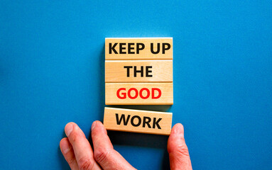 Keep up the good work symbol. Concept words Keep up the good work on wooden blocks. Businessman...