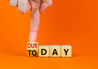 Today is our day symbol. Businessman turns the wooden cube and changes concept words Today to our day. Beautiful orange background, copy space. Business, motivation today is our day concept.