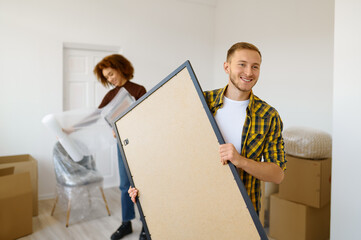 Couple packing furniture preparing for home moving