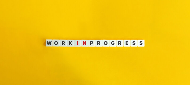 Work In Progress Expression on Letter Tiles on Yellow Background. Minimal Aesthetics.