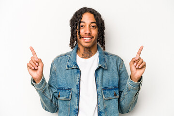 Young African American man isolated on white background indicates with both fore fingers up showing...
