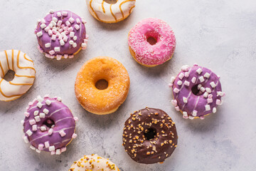 Tasty sweet donuts on a gray background