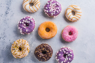 Tasty sweet donuts on a gray background