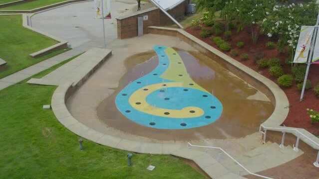 Fly over top down view of water fountain with rhythm spouts movement
