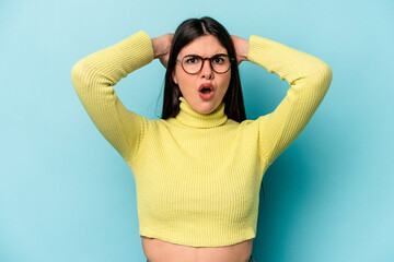 Young caucasian woman isolated on blue background surprised and shocked.