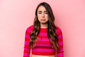 Fototapeta premium Young caucasian woman isolated on pink background sad, serious face, feeling miserable and displeased.