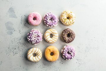 Tasty sweet donuts on a gray background