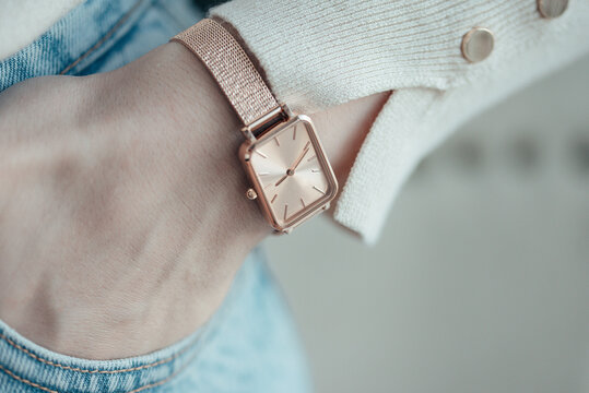 Beautiful stylish classic golden watch on woman hand. Close up photo.