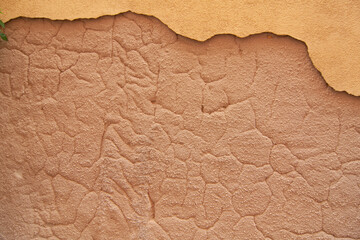closeup vida le a Big chip on an old adobe wall