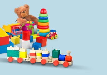 Baby kids toys background. Wooden toy train, wood stacking pyramid tower and colorful wood bricks