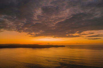 Fototapeta na wymiar Aerial sunrise seascape with low clouds