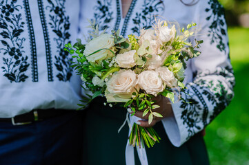 Wedding bouquet in the hands of the bride. Beautiful bridal bouquet