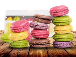 French dessert for coffee. Multicolored macarons or macaroons on desk