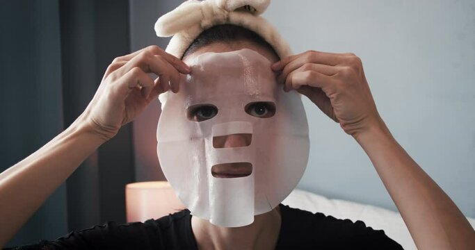 Woman at home apply face mask after doing a skincare beauty routine with product application