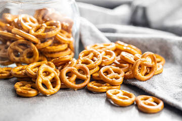 Mini pretzels. Crusty salted snack on kitchen table.