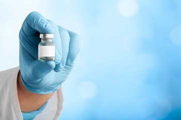 Fototapeta premium The nurse hand holding the covid vaccine booster shot
