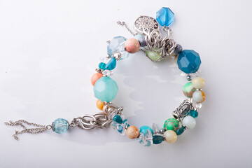 jewerly bracelet with semiprecious stones around  white background. top view