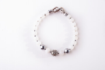 jewerly bracelet with natural Moonstone semiprecious stones around  white background. top view