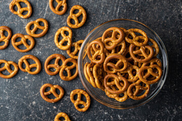 Mini pretzels. Crusty salted snack in bowl.