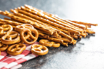 Mini pretzels and salted sticks. Crusty salted snack on kitchen table.