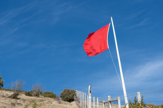 Close up of a red flag blowing in the wind