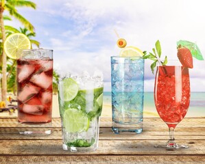Cocktails drinks. Classic alcoholic long drink with berries, lime, herbs and ice