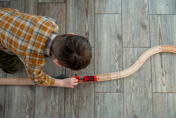 Little boy play in train in room at home © Masson